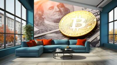 Golden Bitcoin lies on the banknotes.New virtual money. Crypto currency top view. Real coins of bitcoin on banknotes of one hundred dollars. Exchange, commercial. online business concept. Wall mural