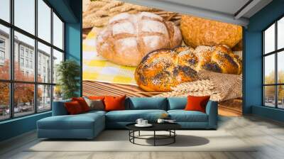 Many mixed breads and rolls shot from above. Wall mural