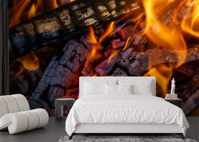 Red hot charcoal and a flame of fire.Close-up of fire, glowing charcoal and hot embers. The texture of flaming burning firewood. Wall mural