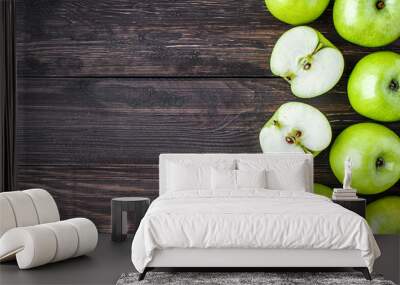 Ripe green apples and apple slices on old wooden background.Vegetables for diet and healthy eating.Organic food. Place for text. Top view Wall mural