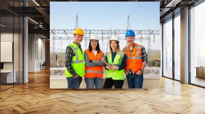 Group portrait of young workers in electric power station Wall mural