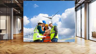 Young engineers and workers having a meeting at wind farm Wall mural