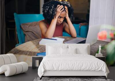 African American worried female watching laptop in cafeteria Wall mural