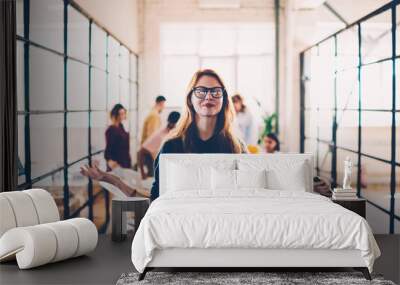 Attractive female in eyeglasses meditating during working process in coworking space finding inspiration, happy young woman with clothes eyes enjoying job with calmness and concentrated on idea Wall mural