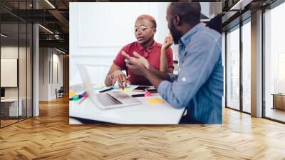 Black female consultant giving advice to male client Wall mural