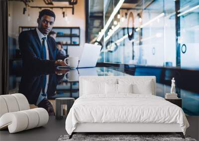 Black man in formal wear working near window Wall mural