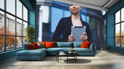 Cheerful caucasian business woman in stylish skirt suit enjoying time for messaging via modern digital tablet using high speed 4g internet in roaming for making business deals in offline mode Wall mural