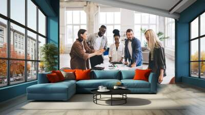 Cheerful colleagues working in spacious office and chatting Wall mural