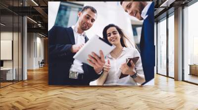 Cheerful diverse colleagues working on tablet Wall mural