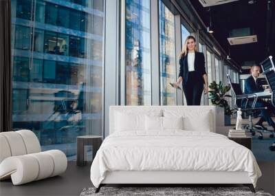 Cheerful elegant businesswoman walking with tablet in boardroom Wall mural