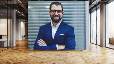 Confident cheerful male leader in stylish suit looking at camera and smiling during working time in office company, portrait of happy director in optical spectacles for provide eyes protection Wall mural