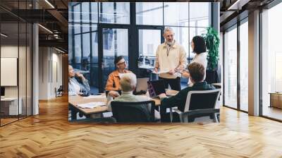 Confident multiethnic colleagues having conversation in office Wall mural