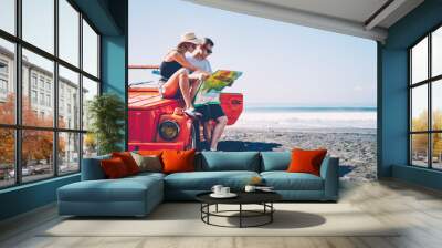 Couple in love searching route for roadtrip spending summer vacation together renting vintage cabriolet,male and female hipsters traveling by automobile on tropical island talking about sightseeing Wall mural