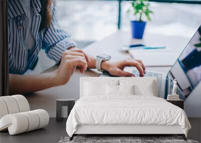 Cropped image of female hands searching web information during social networking via modern laptop computer, woman connecting to wifi wireless for making online netbook booking and banking Wall mural