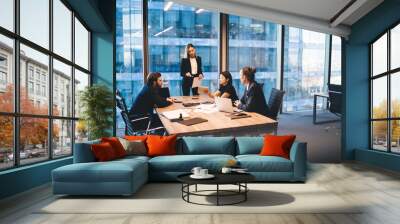 Diverse group of colleagues working on project together in boardroom Wall mural