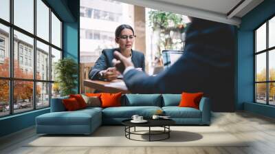 Elegant lady talking to partner at workplace Wall mural