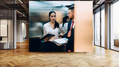 Focused woman with man in lift Wall mural