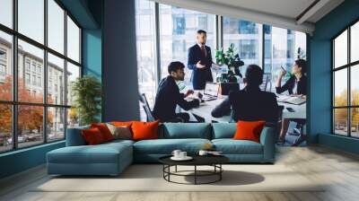 Group of colleagues discussing business ideas at conference in modern workspace Wall mural