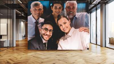 Group of colleagues taking pictures in office Wall mural