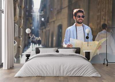 Happy man with map on street Wall mural