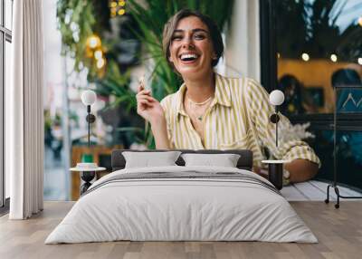 Happy woman having coffee break in outdoor cafe Wall mural