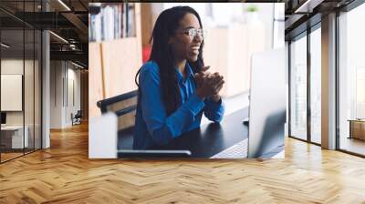 Joyful African American businesswoman using computer at office Wall mural