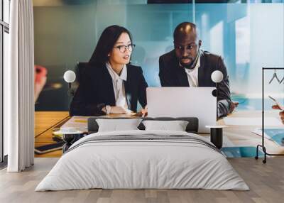 Multiethnic business partners working on project together with laptop at conference room Wall mural