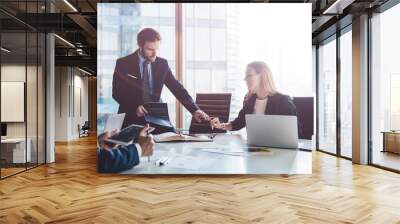 Professional financial experts discussing details of report during cooperation in office interior Wall mural