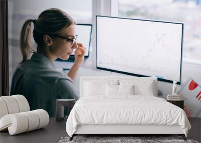 Professional woman with devices at desktop Wall mural