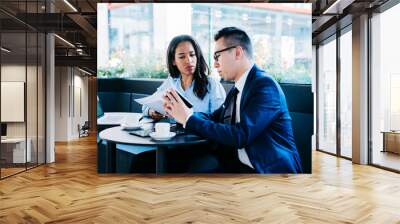 Professional young man and woman meeting in cafe Wall mural