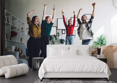 Screaming youth celebrating victory during sport translation on TV Wall mural