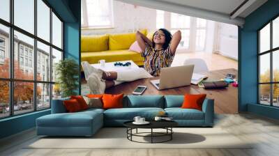 Smiling black student relaxing after working on laptop Wall mural