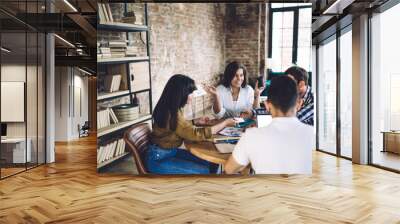 Smiling creative people discussing project in loft office Wall mural