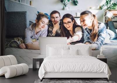 Students watching laptop at home Wall mural