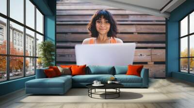 Surprised woman using laptop while studying online Wall mural