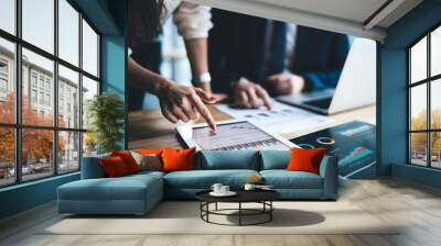 Young businessman and woman in formal sitting in office using tablet working on financial charts in workplace in company Wall mural