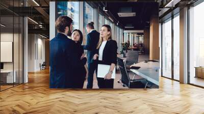 Young professional male and female colleagues discussing strategy on cooperation during meeting in office interior, team 30s of caucasian woman and man business partners having conversation Wall mural