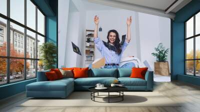 Young woman celebrating successful project at home Wall mural