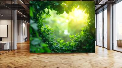 An image of two beautiful, textured tree trunks with juicy green leaves in the rays of sunlight. Wall mural