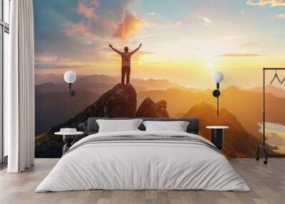 Successful businessman celebrating success on cliff, backlit silhouette of a happy man jumping to the top of the mountain. Wall mural