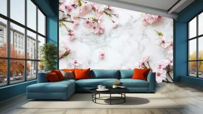 The blossoms of a sakura tree sit on a white marble table and are framed in a flat lay. Wall mural