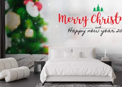 Christmas and Happy new year 2020 on empty wood table top on blur bokeh christmas tree background with snowfall - can be used for display or montage your products. Wall mural