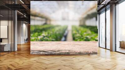 Empty wood table top and blurred green tree and vegetable in greenhouse of agricultural farms. background - can used for display or montage your products. Wall mural