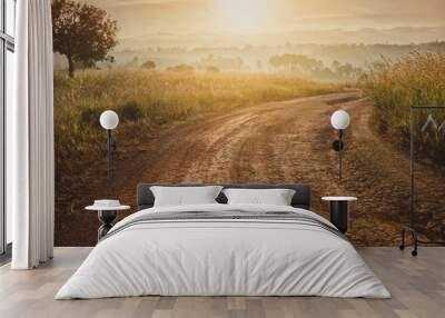 Road in the field against the sunrise background with nature tree.Beautiful landscape for adventure travel.Vintage tone. Wall mural