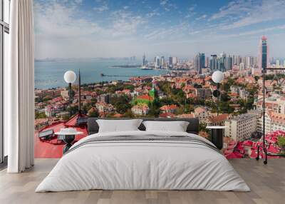 Top view from the hill of Signal Park of red roofs and cityscape of old town and new town seaside of Qingdao, China.Seaside tourist town that is popular with Chinese people. Wall mural