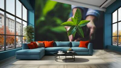 hand holding plant on nature background, concept save the world Wall mural