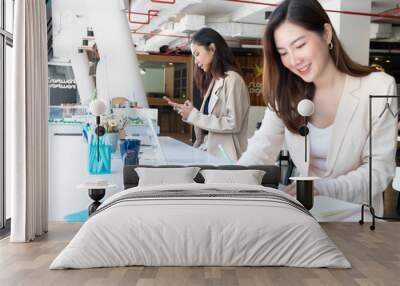 Two businesswomen working on their work in modern office room Wall mural