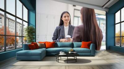 Two women are talking in a room Wall mural