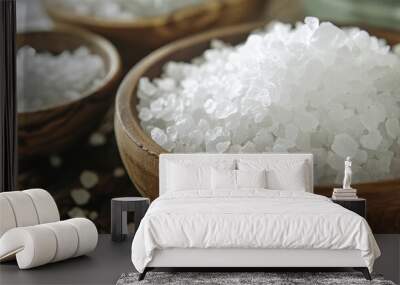 A close-up of coarse sea salt crystals in a wooden bowl, highlighting their natural texture and purity. Wall mural