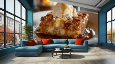 A decadent serving of bread pudding topped with a rich caramel sauce and a scoop of vanilla ice cream Wall mural